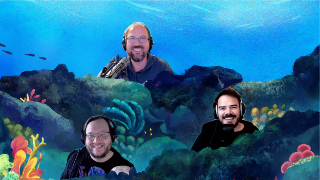 Screenshot unserer Skype-Session. Jörn, Benni und Steffen wurden digital in eine comicartige Unterwasserlandschaft eingefügt. Man sieht Riffstrukturen, Anemonen und Fische.